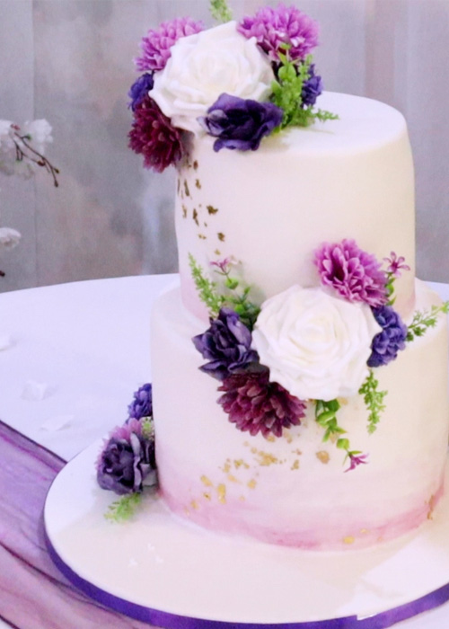 wedding cake with lavendar and white flowers