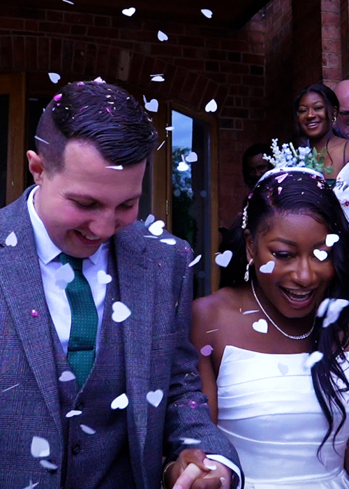 black and white wedding couple being showered with confetti