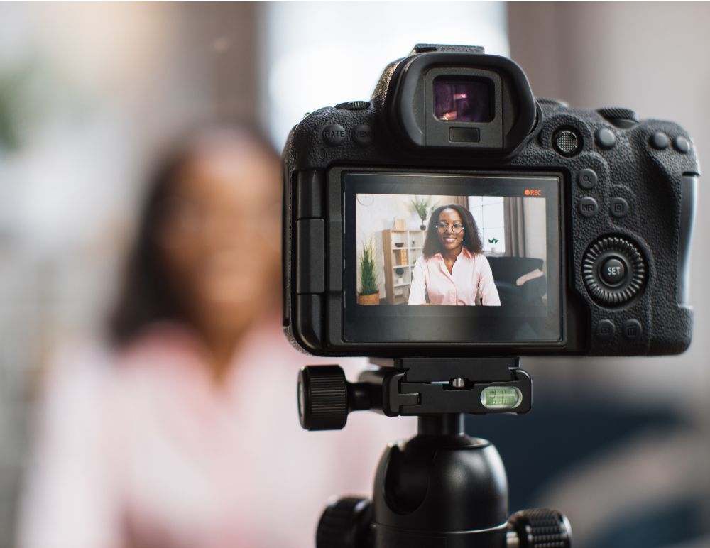 commercial_filming camera pointing at silohette of black woman